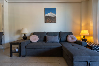 Sofa bed in the living room of Teide View Balcones de Los Gigantes, perfect for relaxation.