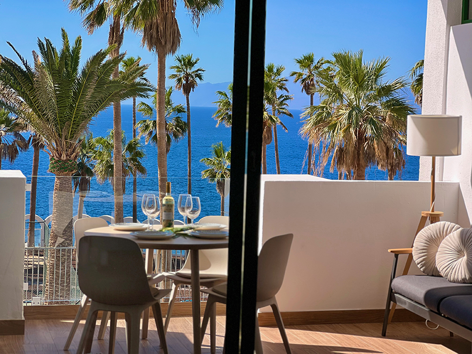 Oceanfront terrace in Callao Salvaje, Tenerife, surrounded by palm trees and the quiet serenity of the island's south.