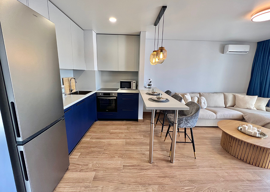 Stylish kitchenette of the apartment with full equipment, perfect for everyday and holiday cooking.