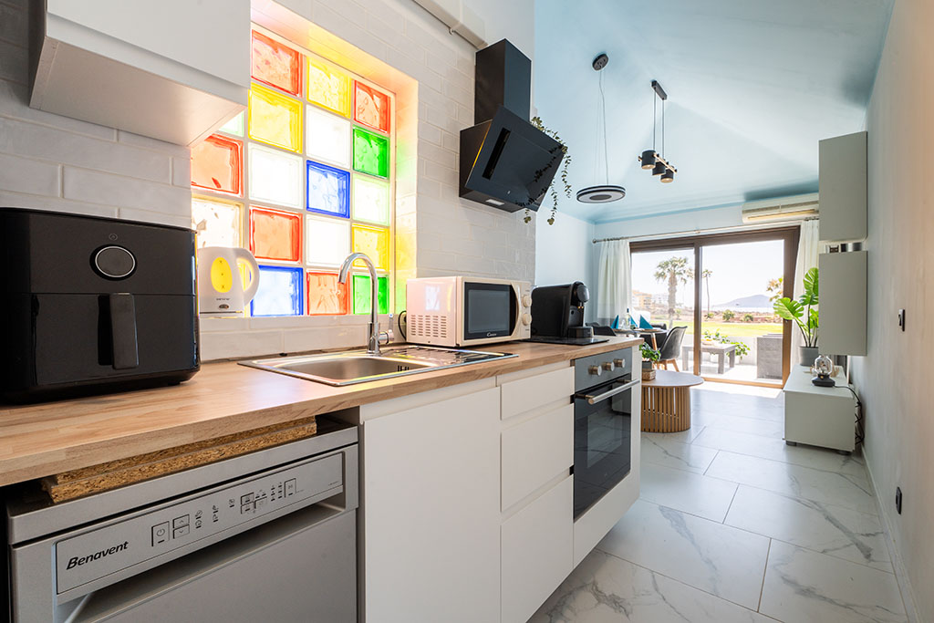 Elegant kitchenette in Amarilla Golf Marina Vista Mar with a clear construction and a designer color accent.