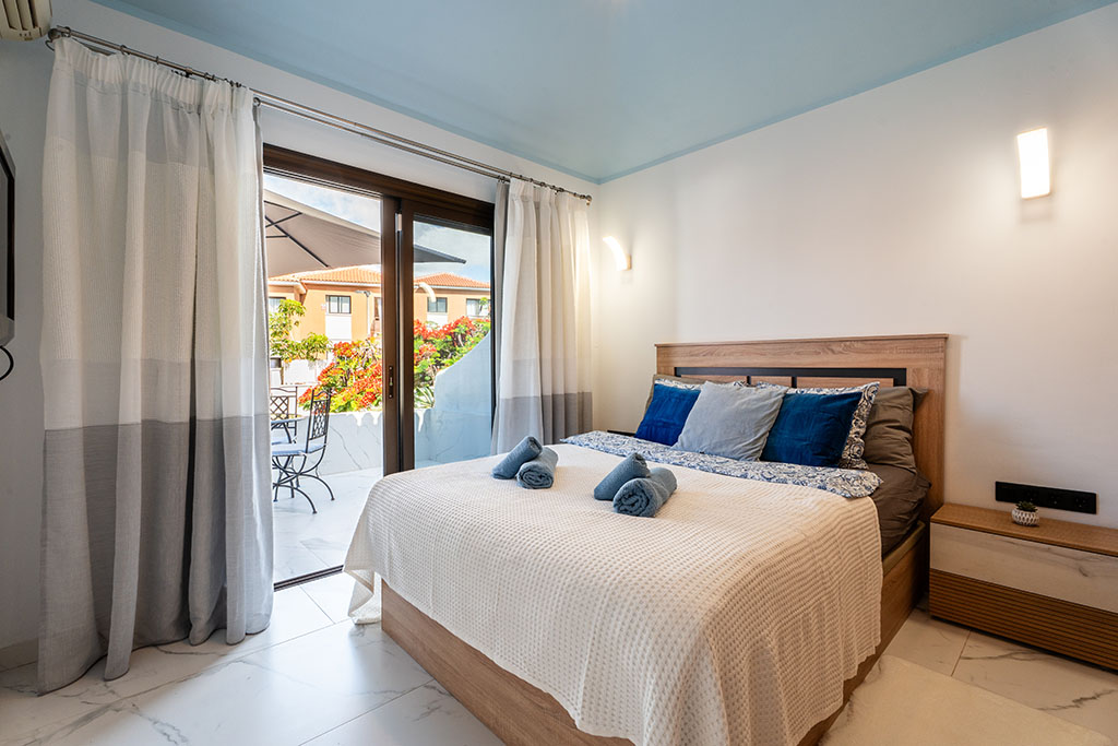 Bedroom in Amarilla Golf Marina Vista Mar with terrace exit and natural light.