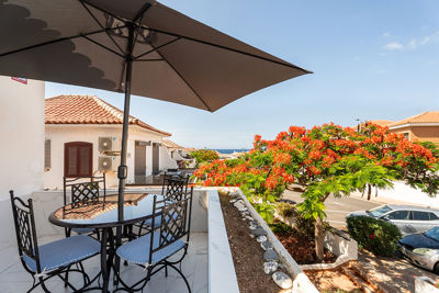 Intimate apartment terrace with space for morning coffee and views of the surrounding buildings.