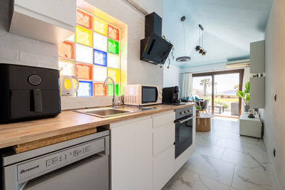 Elegant kitchenette in Amarilla Golf Marina Vista Mar with a clear construction and a designer color accent.