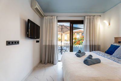 Bedroom with large bed and direct access to the outdoor area of the apartment.