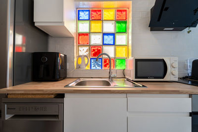 Exclusive kitchen with illuminated decorative wall and careful detail finish.