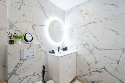 Modern bathroom featuring a shower, stylish sink, and decorative tiles in vacation apartment, Canary Islands
