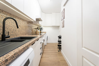 Modern kitchen with wooden cabinets and appliances in a vacation rental in Golf del Sur, Canary Islands