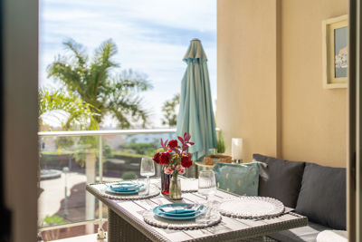 Spacious terrace with comfortable furniture and ocean views in a luxury apartment located in Golf del Sur, Canary Islands