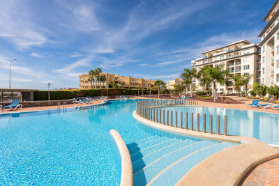 Spacious pool area surrounded by tropical gardens at the vacation rental La Vista del Mar, Canary Islands