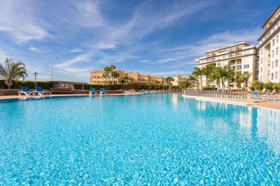 Spacious private pool surrounded by sun loungers at the vacation apartment in Golf del Sur, Canary Islands