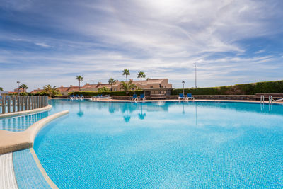 Spacious communal pool surrounded by gardens in a luxury apartment in Canary Islands, Golf del Sur