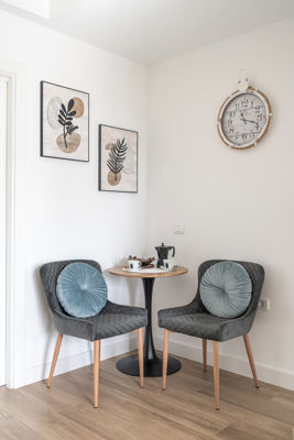 Bright living room featuring modern chairs and cozy decor in a vacation rental in the Canary Islands, Spain.