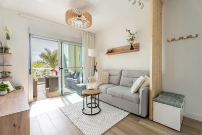 Cozy living room featuring large windows and access to the terrace in a luxury apartment in Golf del Sur, Canary Islands