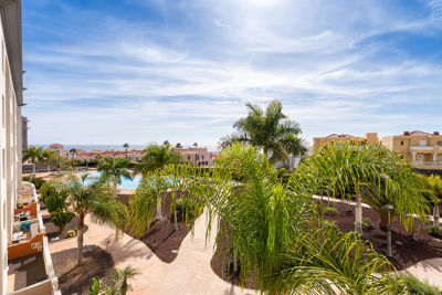 Spacious terrace with outdoor furniture and pool views in a vacation rental in the Canary Islands, Spain