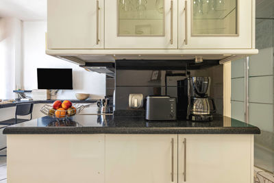 Modern kitchen with appliances and utensils in the Sol del Sur Ocean View apartment, Canary Islands