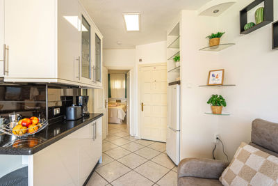 Spacious living room featuring an integrated kitchen, modern decor, and views of the Canary Islands in the vacation rental.