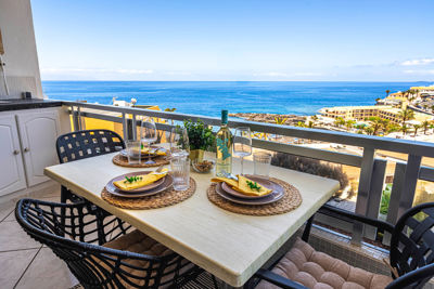 Spacious terrace with outdoor furniture and stunning sea views in the vacation rental Sol del Sur, Canary Islands.