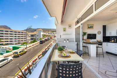 Spacious terrace with outdoor furniture and ocean views in a holiday rental in the Canary Islands, Spain.