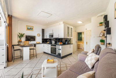 Large living room with big windows and modern decor in a vacation rental apartment in the Canary Islands, Spain.