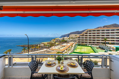 Spacious terrace with outdoor furniture and sea views in vacation rental Sol del Sur, Canary Islands