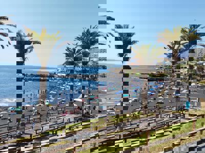 Spacious outdoor area with pool and garden at Sol del Sur Ocean View apartment, located in the Canary Islands, Spain.