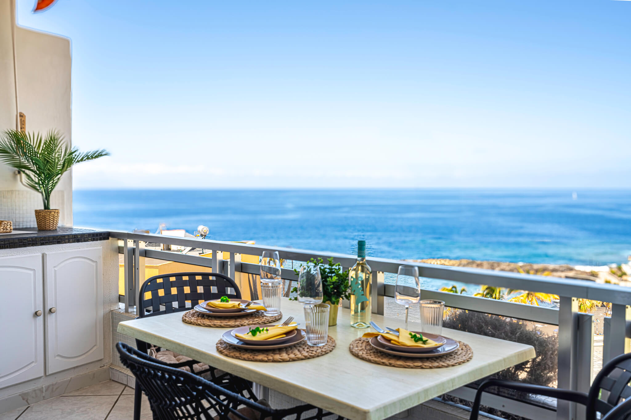 Spacious terrace with comfortable furniture and panoramic sea views in the Canary Islands, perfect for enjoying the sunny weather.