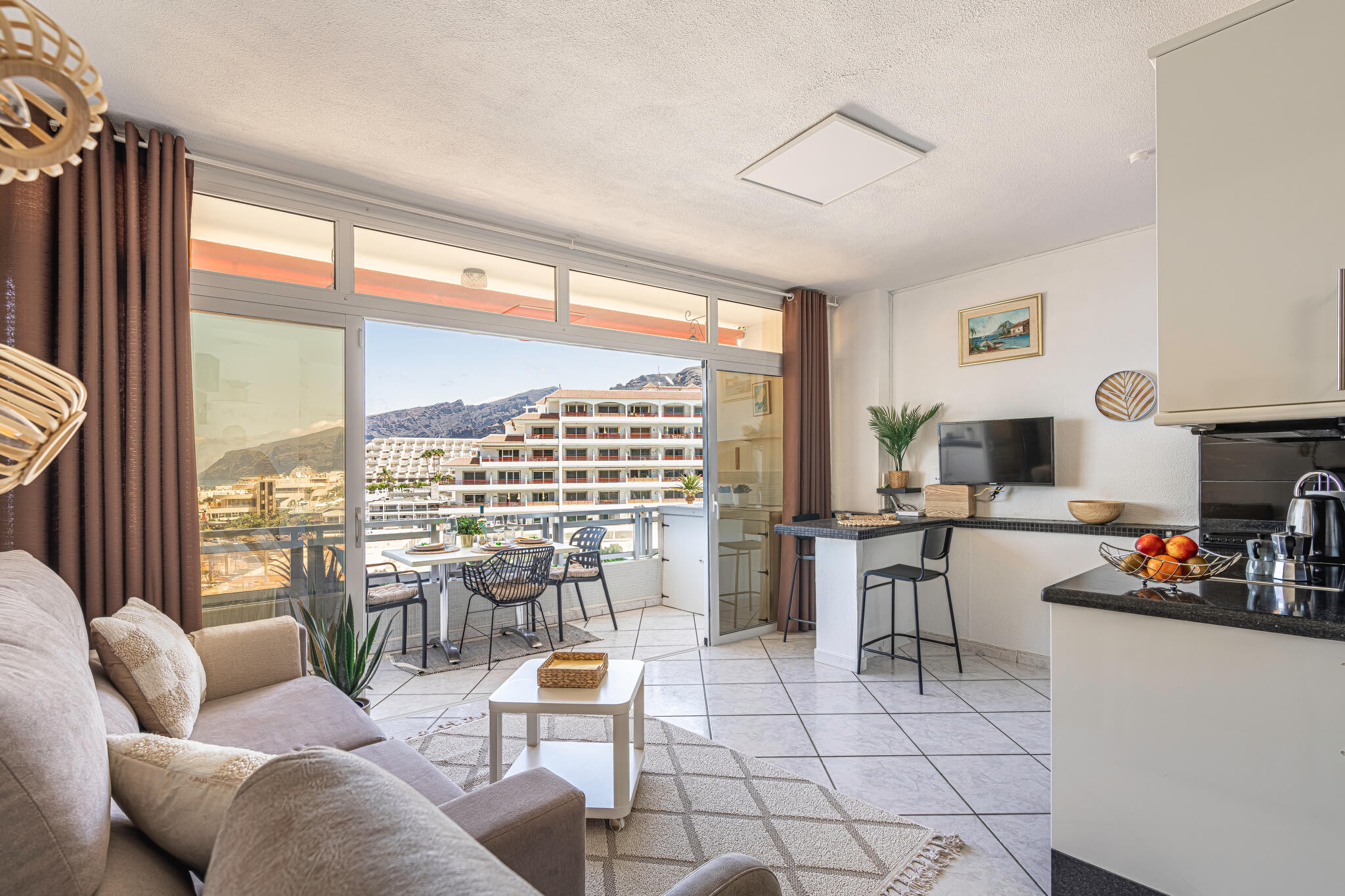 Spacious living room featuring large windows with ocean views in a vacation rental apartment in the Canary Islands